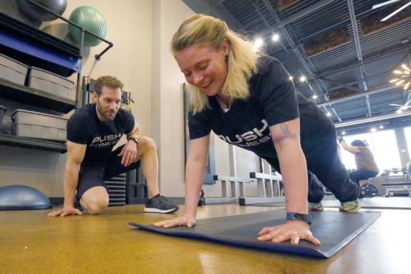 Brian Hill/bhill@dailyherald.comFittest Loser participant Kat Polomsky with trainer Joshua Steckler.